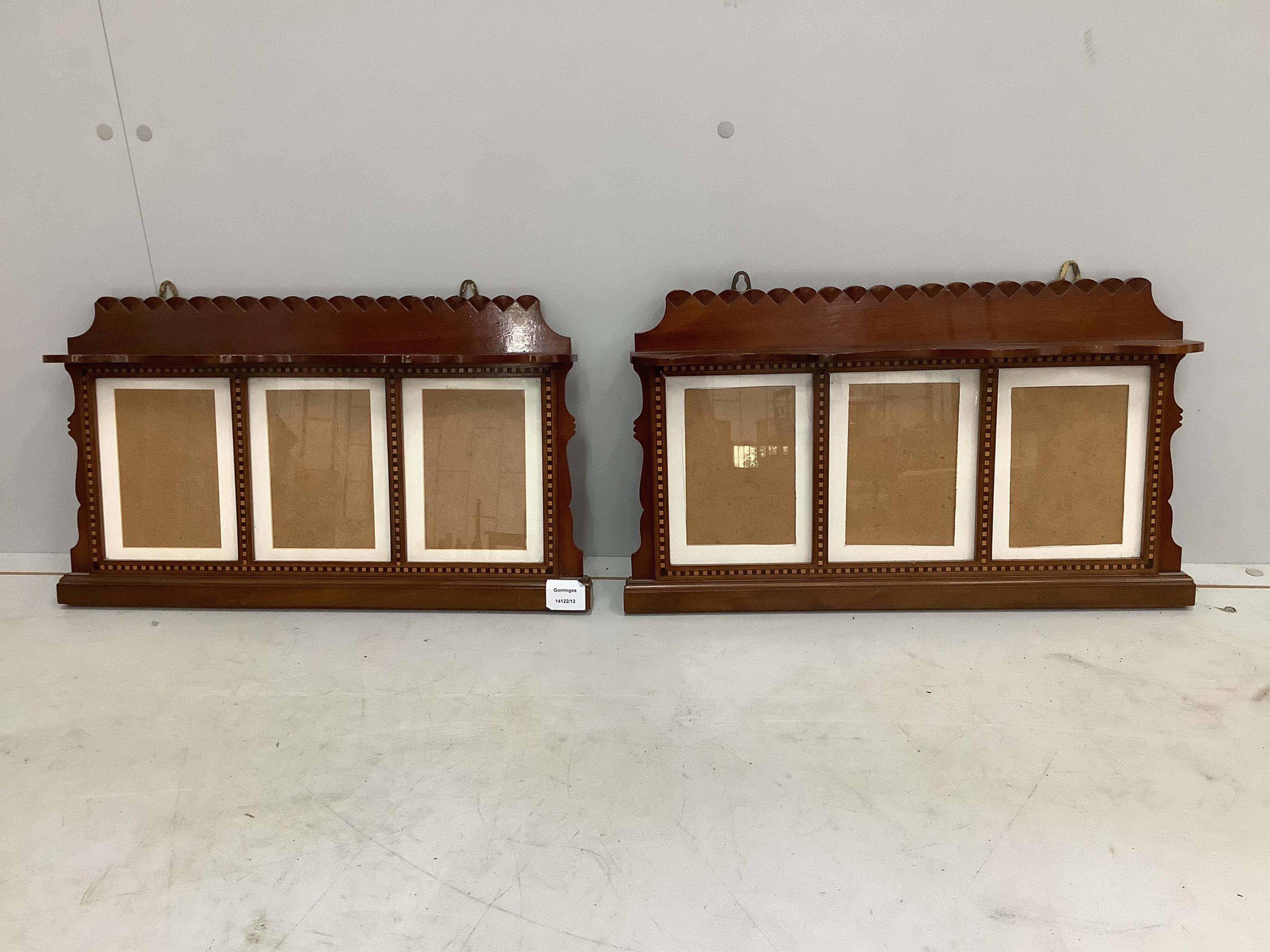 A pair of Edwardian style mahogany triptych wall-hanging photograph frames, width 54cm, height 32cm